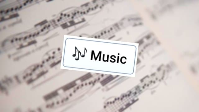 Infinite Craft's Music block atop a blurred image depicting written sheet music